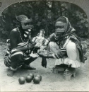 Two Omani girls in Zanzibar playing with a doll 